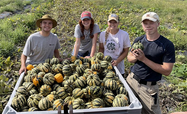 "Students with freshly picked squash"